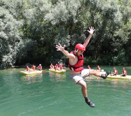 Jumping into refreshing Cetina river on rafting tour from Split
