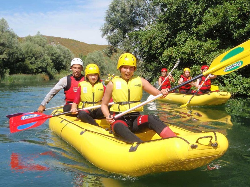 Kids learning how to steer on Cetina river rafting tour