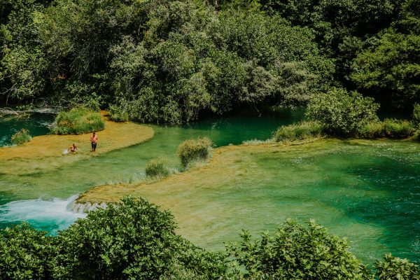 People relaxing on Krka travertine sysstem