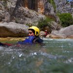 Sliding into the river rapid on Cetina canyoning tour from Split
