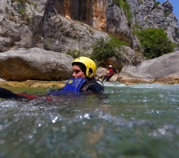 Sliding into the river rapid on Cetina canyoning tour from Split