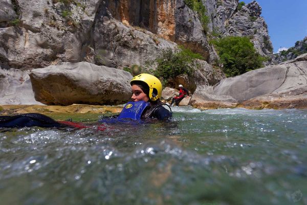 Sliding into the river rapid on Cetina canyoning tour from Split