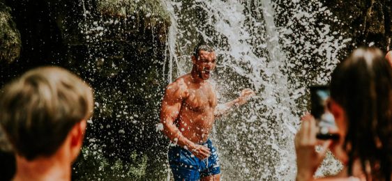 showering under Krka waterfall