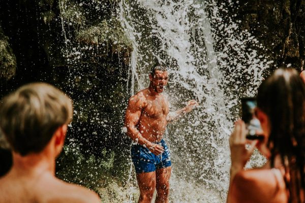 showering under Krka waterfall