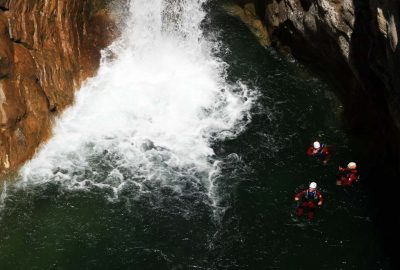 Swimming between the canyon rocks by waterfall on Cetina river