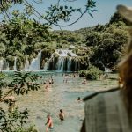 watching people swimming by Krka waterfalls