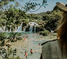 watching people swimming by Krka waterfalls