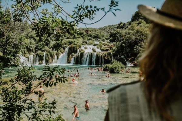 watching people swimming by Krka waterfalls